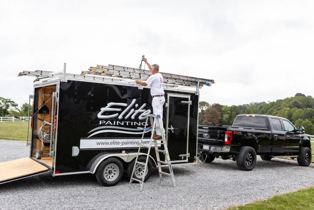 Elite Painting crew loading ladders at a job site near Bedford VA